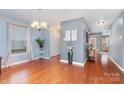 Dining room with hardwood floors, soft blue walls, and a decorative chandelier at 2005 Dunsmore Ln, Waxhaw, NC 28173