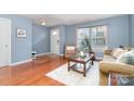 Inviting living room with hardwood floors, soft blue walls, and cozy seating arrangements at 2005 Dunsmore Ln, Waxhaw, NC 28173
