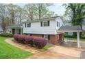 Exterior view showcasing the home's siding, brick accents, and convenient carport at 205 Gamble Ave, Bessemer City, NC 28016