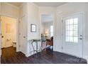 Elegant foyer showcasing dark hardwood floors, a decorative table, and a view into the living area at 2052 Donaldson St, Indian Land, SC 29707