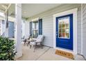 Inviting front porch showcasing seating, a blue door and a welcoming atmosphere at 2052 Donaldson St, Indian Land, SC 29707