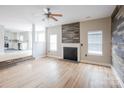 Comfortable living room with fireplace and hardwood flooring, leading to kitchen at 240 Bluffton Rd, Mooresville, NC 28115