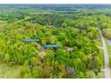 Aerial view of the property surrounded by lush green trees in a serene, secluded setting at 2470 Highway 557 Rd, Clover, SC 29710