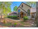 A beautifully landscaped yard leads to this inviting home with a stone-accented entrance and arched windows at 252 Greyfriars Rd, Mooresville, NC 28117