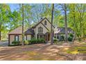 Charming two-story home featuring a well-manicured front yard with lush greenery and mature trees at 252 Greyfriars Rd, Mooresville, NC 28117