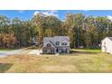 Two-story home featuring brick and siding, black shutters, and a large lawn surrounded by mature trees at 3018 Corinth Church Rd, Monroe, NC 28112