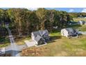 An aerial view of a beautiful gray house surrounded by trees and a large, well-maintained yard at 3018 Corinth Church Rd, Monroe, NC 28112