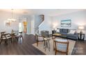 Open-concept living room featuring hardwood floors and modern decor with lots of natural light at 3138 Golden Dale Ln, Charlotte, NC 28262