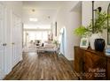 Bright entryway with wood floors, decorative console table and accents, leading into a living area at 4002 Shadow Pines Cir, Indian Trail, NC 28079