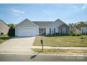 Inviting single-Gathering home featuring a well-kept lawn, a driveway, and a welcoming entrance at 4002 Shadow Pines Cir, Indian Trail, NC 28079