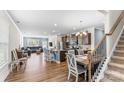 Open-concept living space with hardwood floors, dining area, and staircase, perfect for modern living at 4112 Steel Way, Sherrills Ford, NC 28673