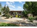 Charming log cabin home boasts a covered porch and well-maintained landscaping at 4478 Fork Rd, Norwood, NC 28128