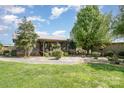 Charming log cabin home with a metal roof, mature trees, and lush green lawn at 4478 Fork Rd, Norwood, NC 28128