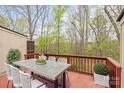 Enjoy outdoor dining on this spacious deck surrounded by lush trees and nature views at 485 Camrose Ne Cir, Concord, NC 28025