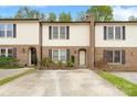 Charming brick townhome featuring well-maintained landscaping and inviting curb appeal at 485 Camrose Ne Cir, Concord, NC 28025
