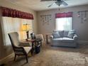Cozy living room featuring a comfortable sofa, chair, ceiling fan, and vintage decor at 523 29Th Avenue Nw Dr, Hickory, NC 28601