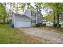 Charming two-story home with stone accents, black shutters and a two-car garage at 6020 Running Deer Rd, Charlotte, NC 28214