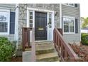 Close-up of the front door with stone accents, the house number, and a small porch at 6020 Running Deer Rd, Charlotte, NC 28214