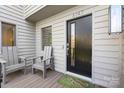 Charming front porch with seating area, complemented by a stylish black door and decorative welcome mat at 6147 Lake Providence Ln, Charlotte, NC 28277