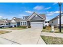 Attractive home with a two-car garage, complemented by a manicured lawn and inviting facade at 7850 Fountaingrass Ln, Sherrills Ford, NC 28673