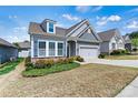 Well-maintained home with a two-car garage and landscaped front yard, exuding suburban charm at 7850 Fountaingrass Ln, Sherrills Ford, NC 28673