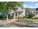 Traditional two-story home with a well-kept lawn and inviting front porch, shaded by a mature tree at 8311 Camberly Rd, Huntersville, NC 28078