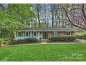 Charming single story home with manicured lawn, mature trees, and inviting front entrance at 9025 Shields Dr, Huntersville, NC 28078