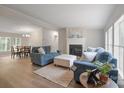 Inviting living room with hardwood floors, fireplace, and comfortable blue sofas, perfect for relaxation and entertaining at 102 Lansdale Ave, Lincolnton, NC 28092