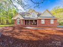 Charming brick home featuring a well-maintained lawn, inviting front porch, and traditional architectural details at 106 Berea Baptist Church Rd, Stanfield, NC 28163