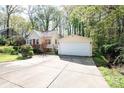 Detached two-car garage with a large concrete driveway and mature trees at 11100 Pine Grove Ave, Mint Hill, NC 28227
