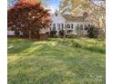Quaint single-story house with welcoming facade, lush lawn, and blossoming flowers at 11170 Nc Hwy 73 E Hwy, Mount Pleasant, NC 28124