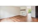 Open living room featuring hardwood floors and a brick fireplace with modern slider door at 1162 Westover Cir, Rock Hill, SC 29732