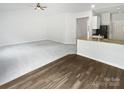 Bright living room showcasing a smooth transition from the hardwood style flooring to new neutral carpeting at 1235 Culver Spring Way, Charlotte, NC 28215