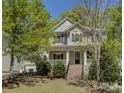 Charming two-story home featuring a welcoming front porch and landscaped front yard at 14103 Grand Traverse Dr, Charlotte, NC 28278