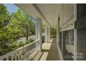 Inviting front porch with white railing and columns, providing a relaxing outdoor space at 14103 Grand Traverse Dr, Charlotte, NC 28278