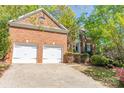 Charming brick home boasts an attached two-car garage and beautifully landscaped front yard at 19113 Southport Dr, Cornelius, NC 28031