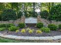 Stone entrance sign to Jetton Cove surrounded by lush landscaping at 19113 Southport Dr, Cornelius, NC 28031
