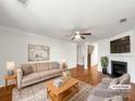 This living room offers a fireplace, hardwood floors and modern decor at 2218 Verde Creek Rd, Charlotte, NC 28214