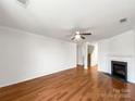 Spacious living room featuring gleaming hardwood floors and a cozy fireplace at 2218 Verde Creek Rd, Charlotte, NC 28214