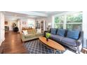 Bright living room featuring hardwood floors, neutral paint, two sofas, and a large picture window at 2404 Finchley Dr, Charlotte, NC 28215