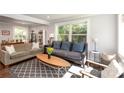 Open concept living room with large windows offering lots of natural light and views of the exterior at 2404 Finchley Dr, Charlotte, NC 28215