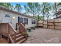 Backyard with wooden fence and deck with stone patio and plants at 2749 Old Nation Rd, Fort Mill, SC 29715