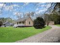Charming home features a covered front porch and a well-maintained yard at 308 Birch St, Lowell, NC 28098