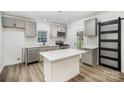 Modern kitchen with stainless steel appliances, island, and ample cabinet space at 308 Birch St, Lowell, NC 28098