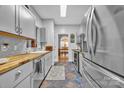 Well-lit kitchen boasts butcher block countertops, stainless steel appliances, and decorative backsplash at 3565 Laboratory Rd, Lincolnton, NC 28092