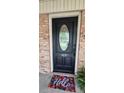 Elegant black front door with decorative glass insert and 'Hello' door mat at 413 Parallel Dr, Harrisburg, NC 28075