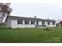 A lovely home featuring a brick exterior, black shutters, and a lush green lawn at 436 Old Nc 90 Hwy, Taylorsville, NC 28681