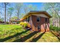 Side exterior view of the brick home with a covered carport and green lawn at 444 27Th Avenue Nw Cir, Hickory, NC 28601
