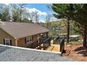 Inviting backyard featuring a multi-level deck with lake access and waterfront views at 458 Pinehaven Dr, Badin Lake, NC 28127