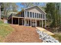 Beautiful lake house with a wall of windows, spacious deck, and boat ramp to the water at 458 Pinehaven Dr, Badin Lake, NC 28127